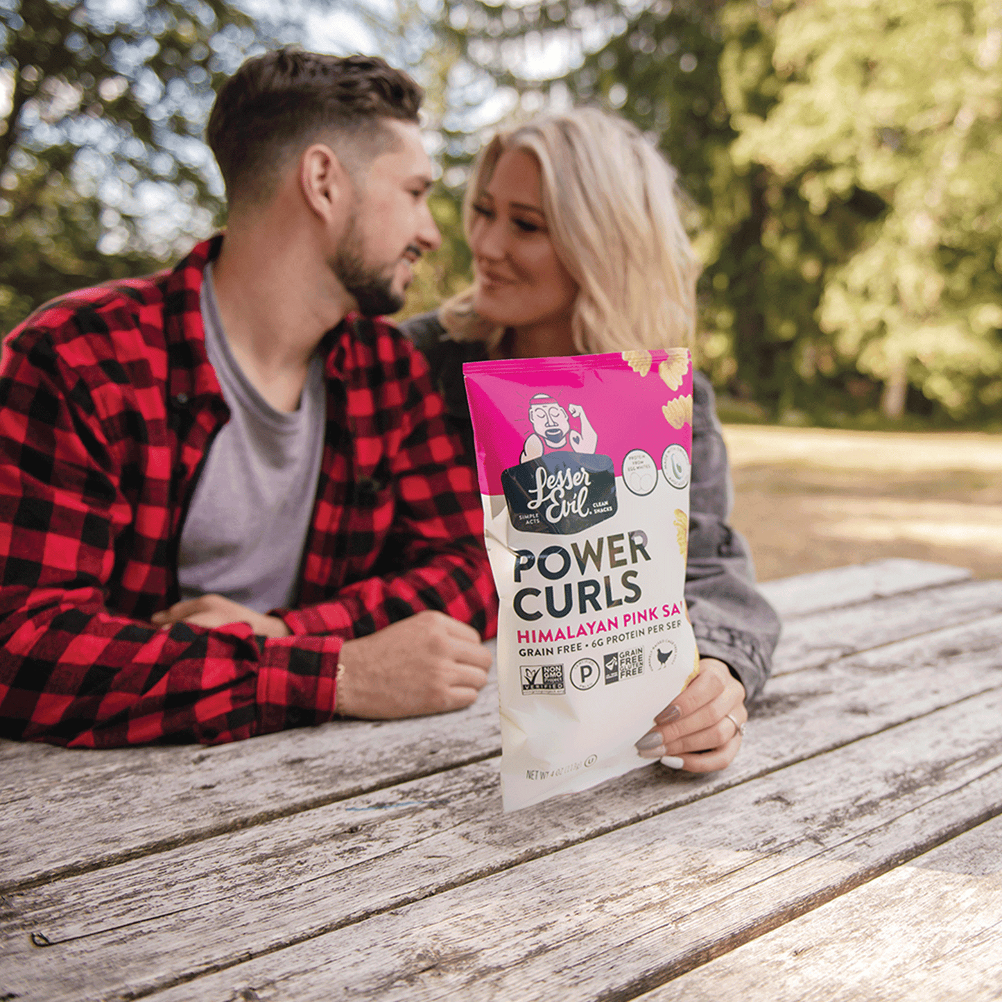 man and woman with bag of pink salt power curls